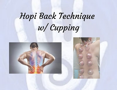 Hopi back and cupping technique session with a man holding his lower back in pain and a lady with cups on her back